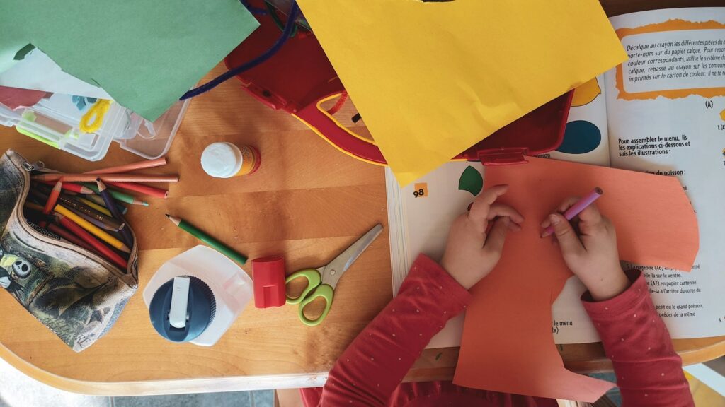 Picture of a child cutting out and doing craft work at a c&k kindergarten
