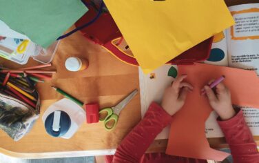 Picture of a child cutting out and doing craft work at a c&k kindergarten