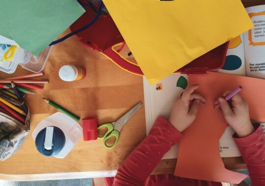 Picture of a child cutting out and doing craft work at a c&k kindergarten